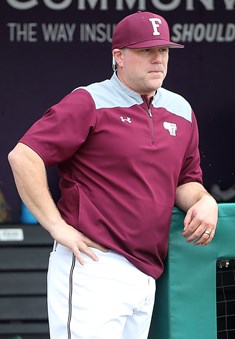 Head Coach Kevin Leighton Leaning on the dugout