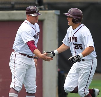 Head Coach Kevin Leighton high fiving player